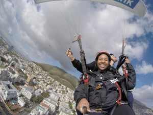 Happy tandem paragliding passenger